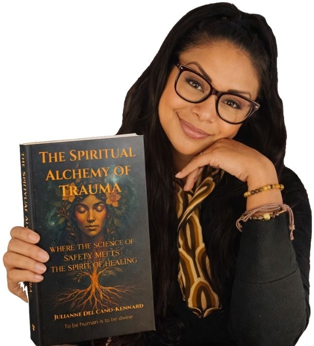 Jules holding The Spiritual Alchemy of Trauma book, representing embodied healing and Wholality-based trauma recovery.